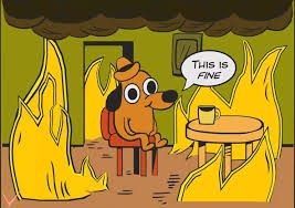 The 'This is fine' dog sitting at the table as flames close in — still perfectly calm